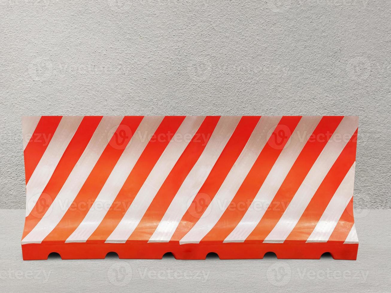 Red and white plastic blocks the walkway. on the cement background photo