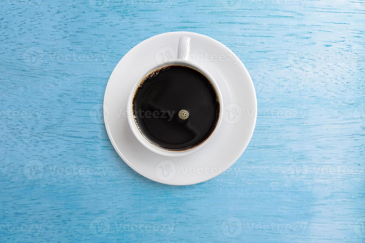 coffee mug, top view, isolated on blue wooden table photo