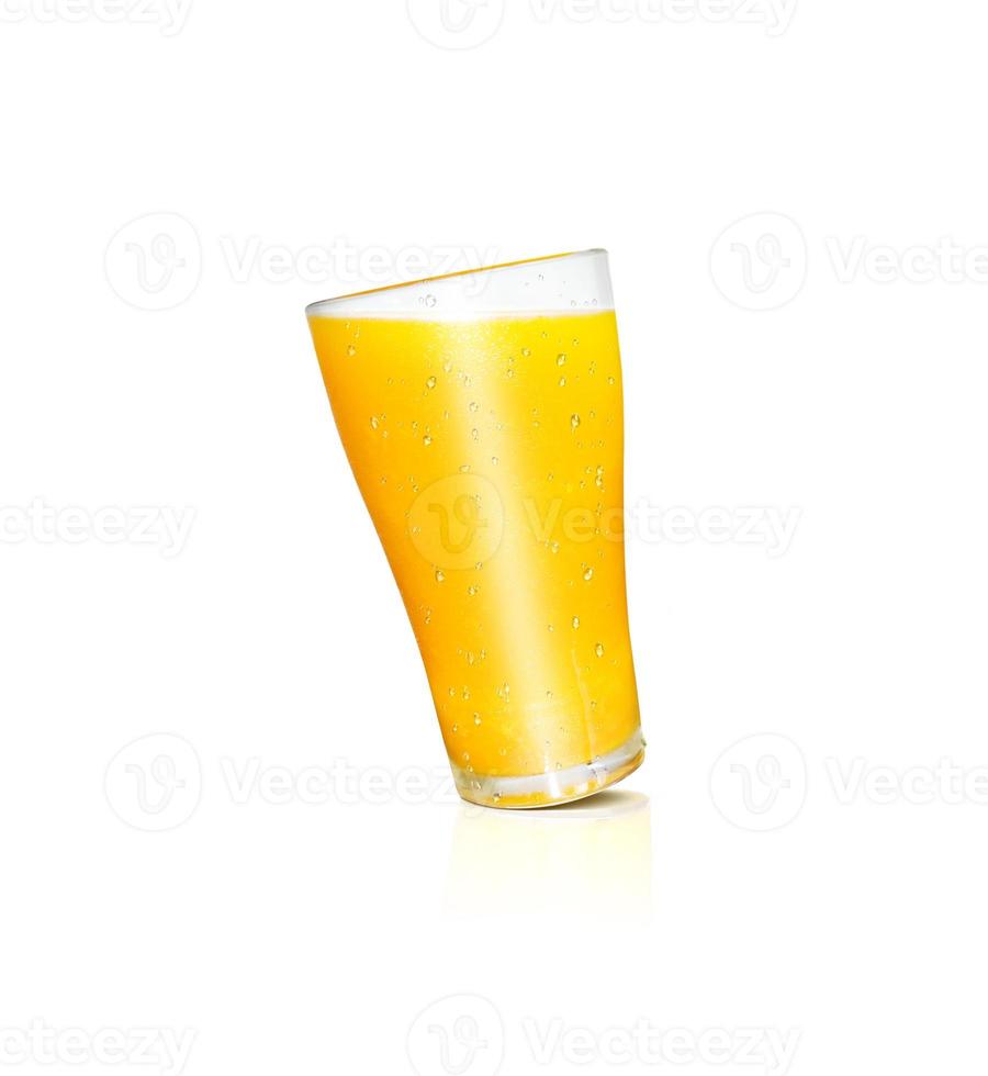 A glass of orange juice has orange pulp mixed on a white background. with reflections of orange glass photo