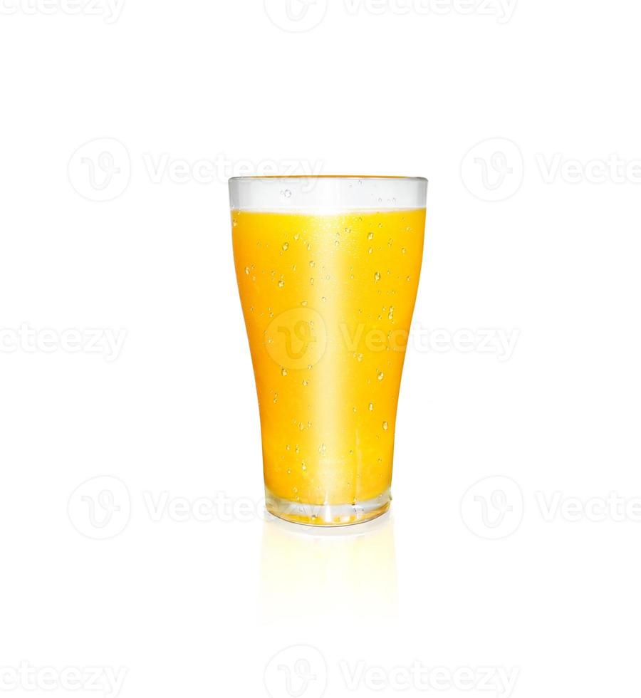 A glass of orange juice has orange pulp mixed on a white background. with reflections of orange glass photo