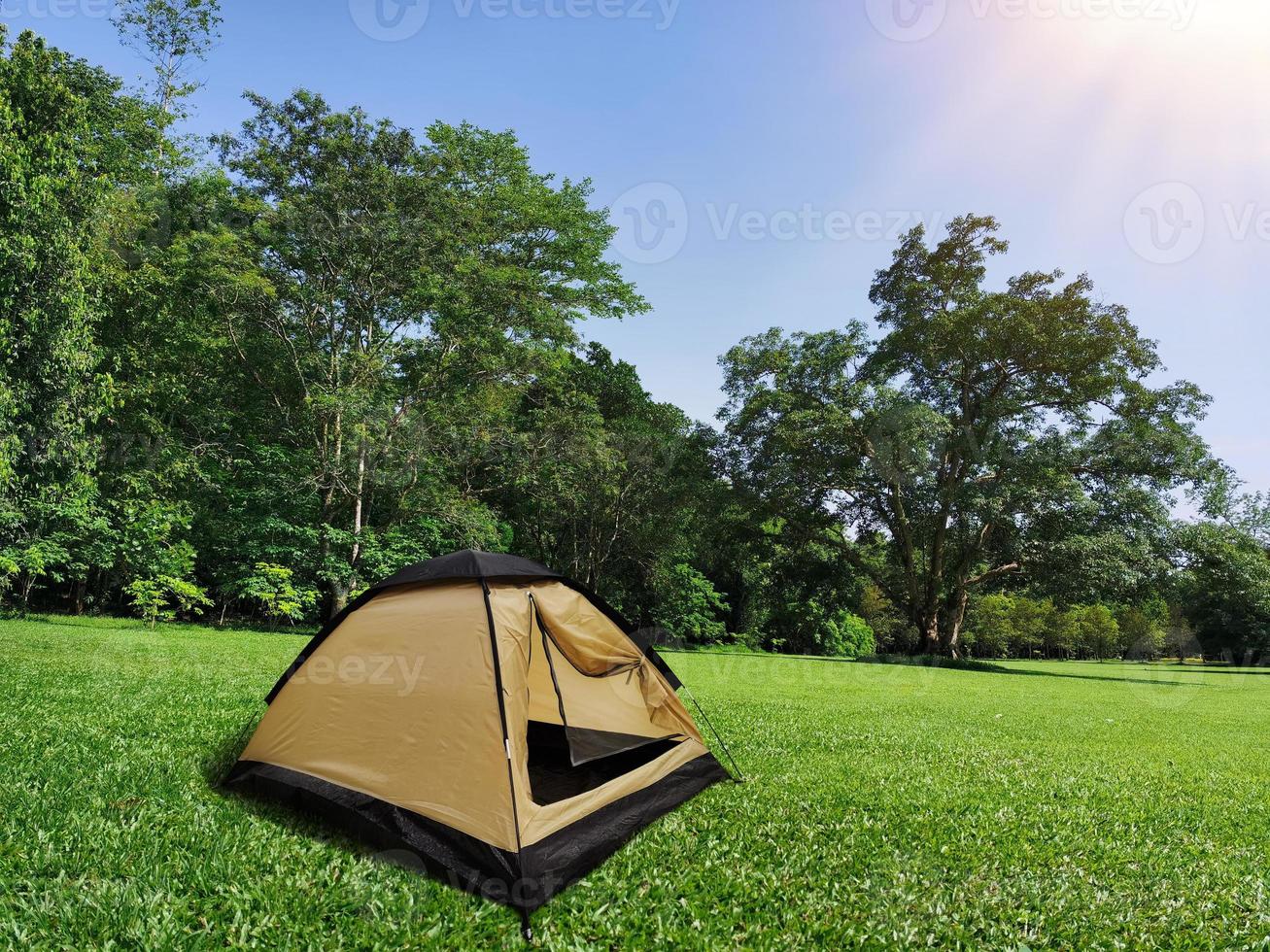 Travel tent camping in the open grass in the forest. photo
