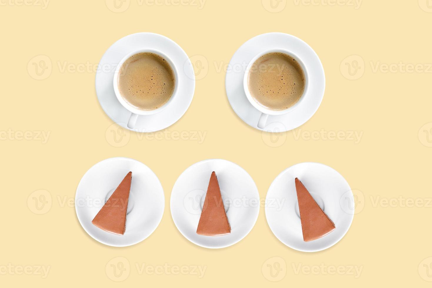 Coffee mug with chocolate cake, top view, isolated on light brown. photo