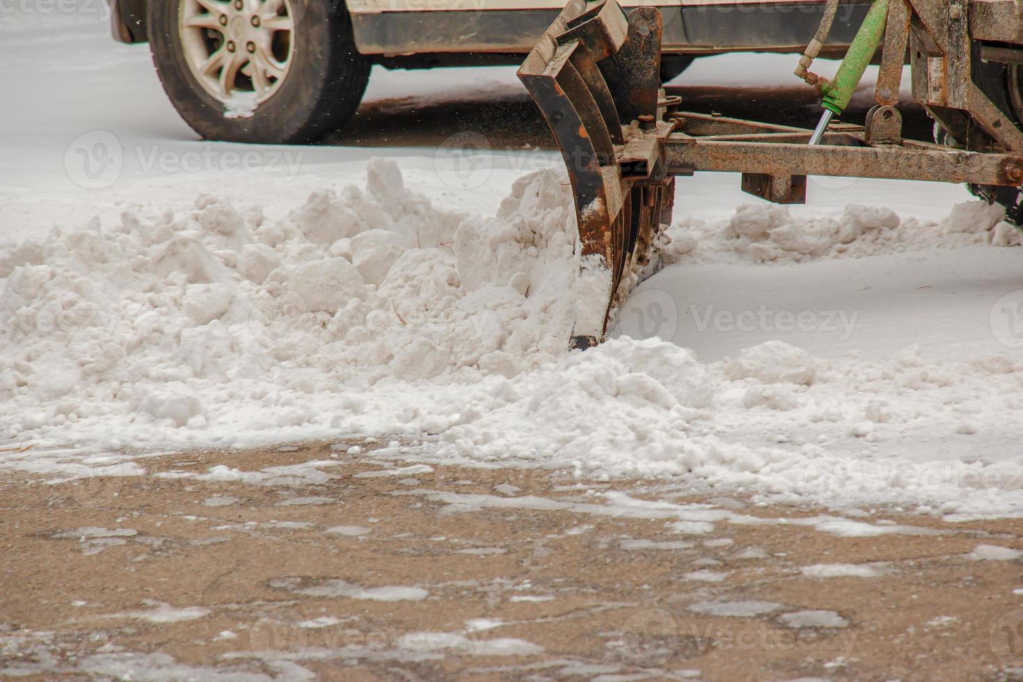 Snow removal from the streets with the help of special equipment in winter photo