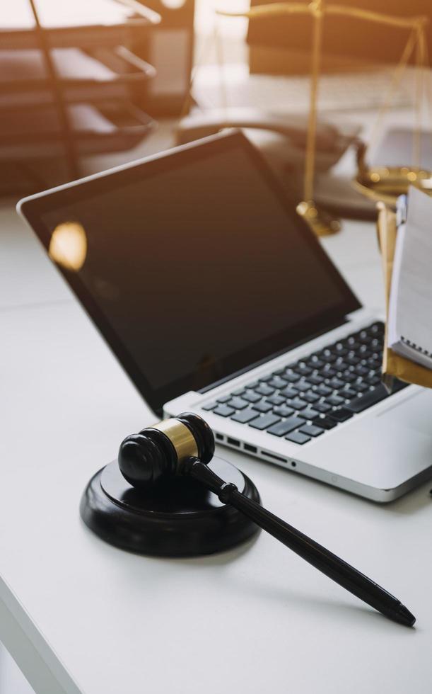 Male lawyer working with contract papers and wooden gavel on tabel in courtroom. justice and law ,attorney, court judge, concept. photo