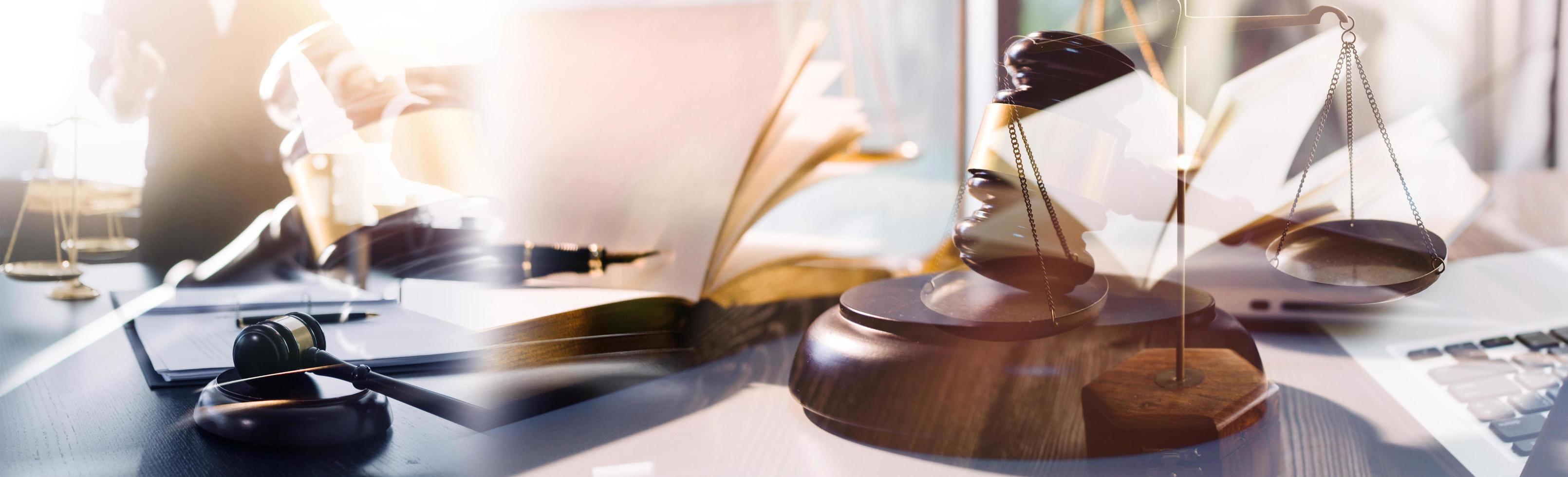 Judge gavel with Justice lawyers having team meeting at law firm in background. Concepts of law. photo