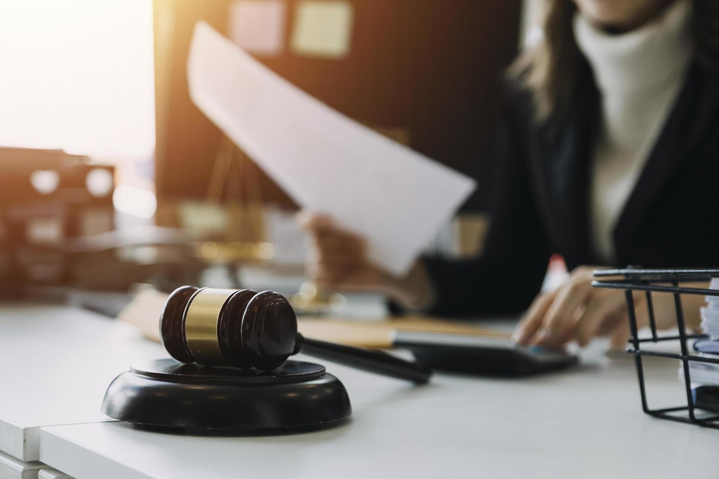 Male lawyer working with contract papers and wooden gavel on tabel in courtroom. justice and law ,attorney, court judge, concept. photo