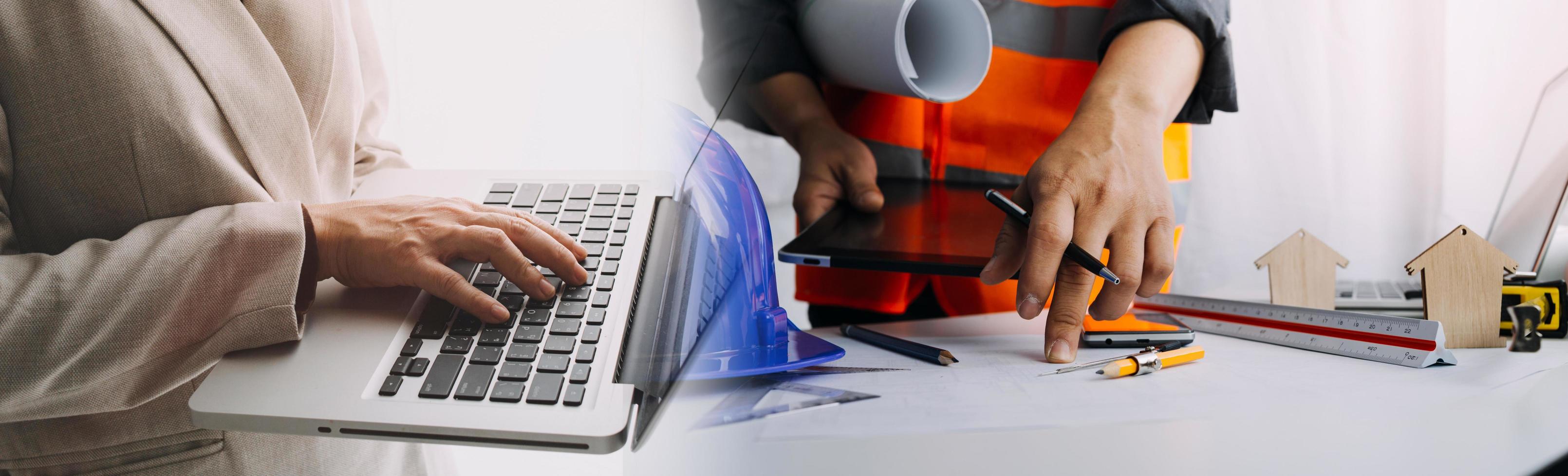 business hand working and laptop with on on architectural project at construction site at office desk in office photo