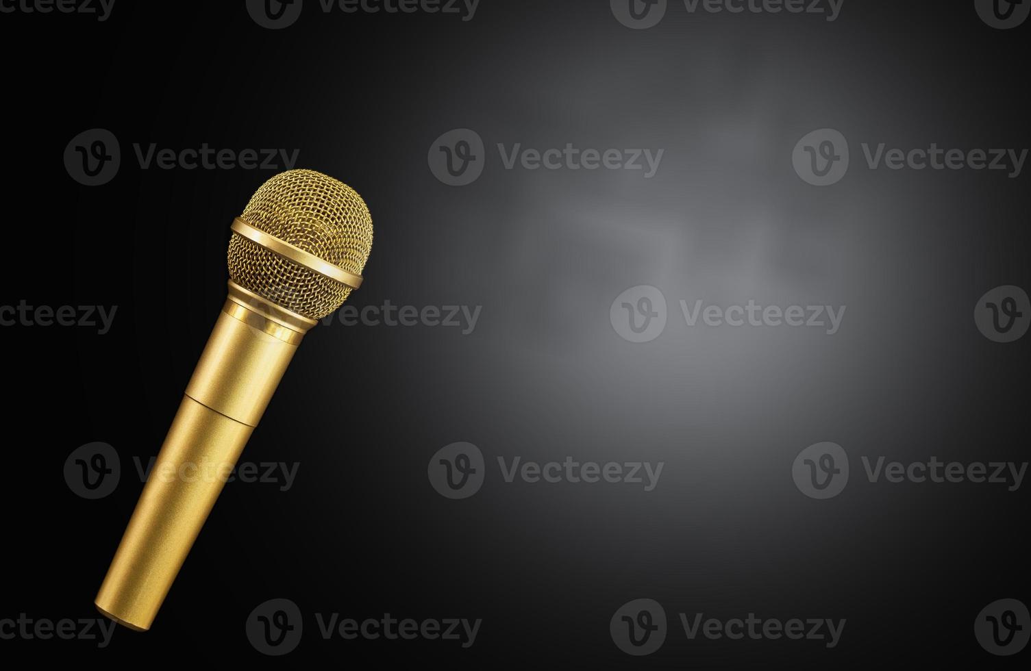 Golden microphone on black background. photo