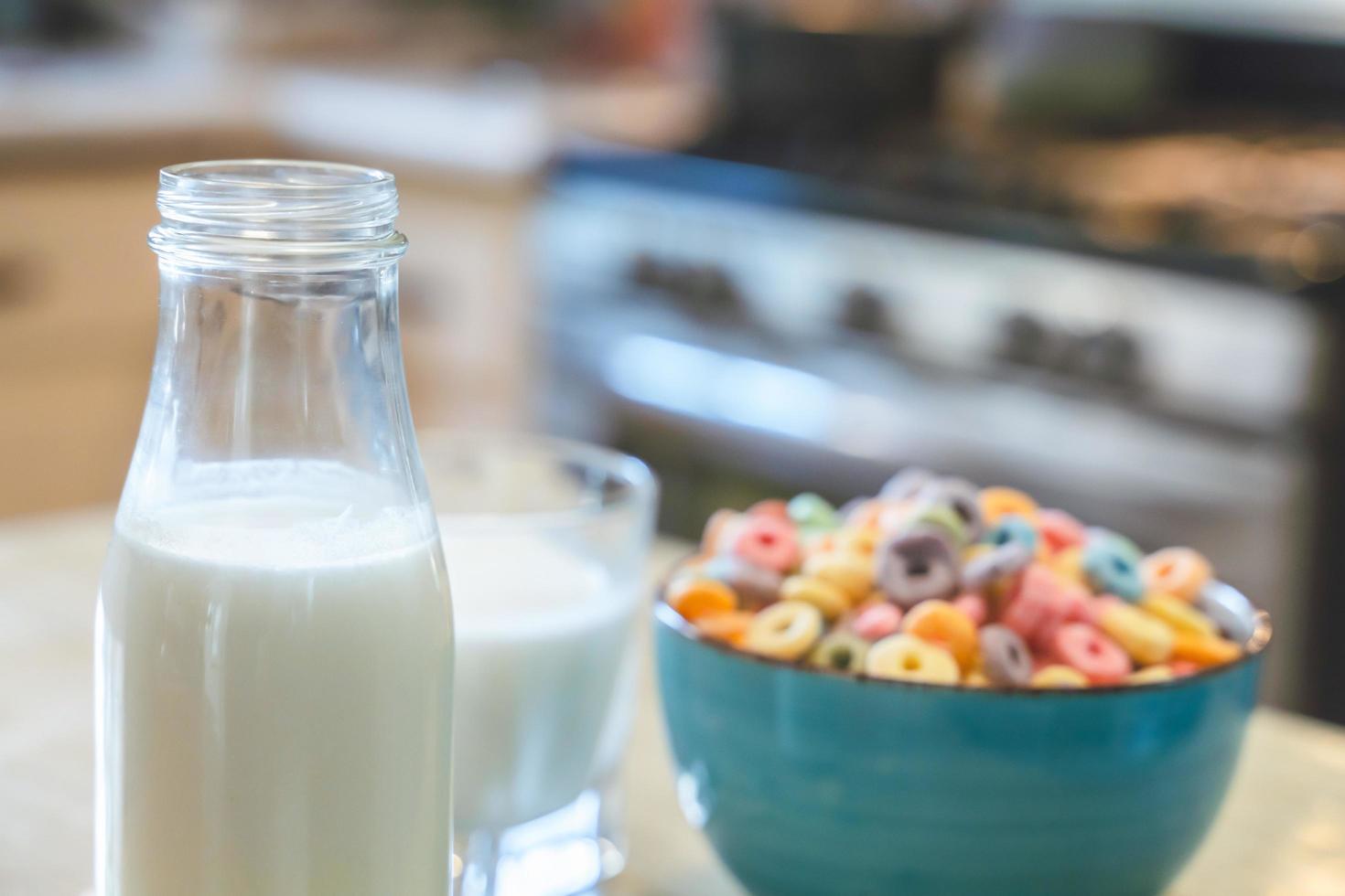 Bowl of colorful children's cereal and milk isolated on wood table with Text space photo