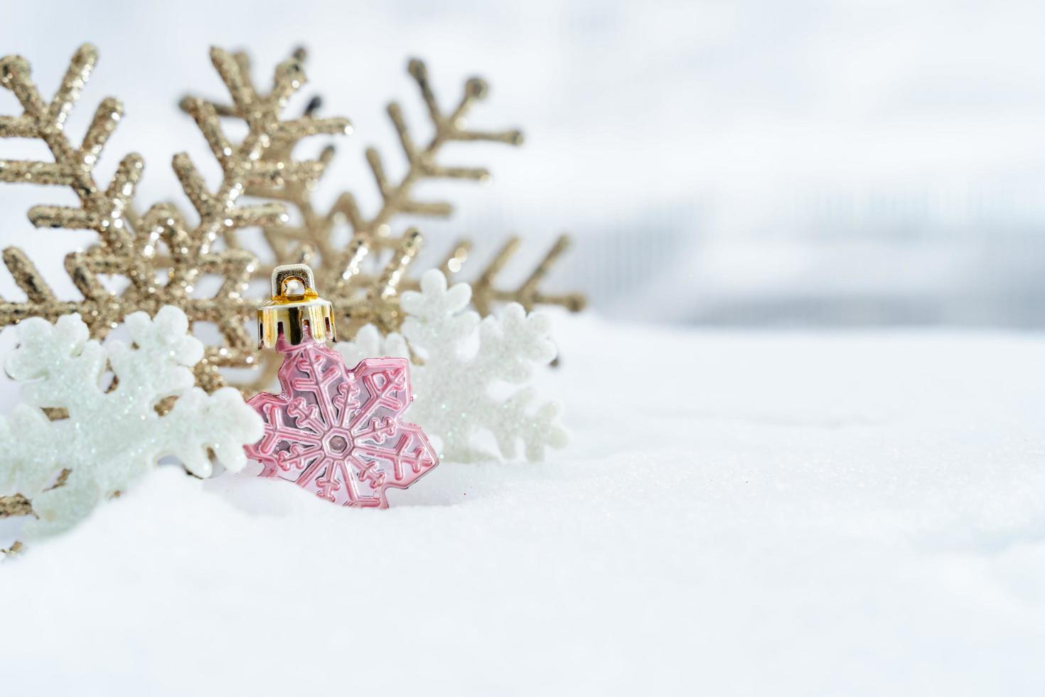 Christmas of  winter - Christmas balls with ribbon on snow, Winter holidays concept. Christmas red balls, golden balls, pine And Snowflakes decorations In Snow Background photo