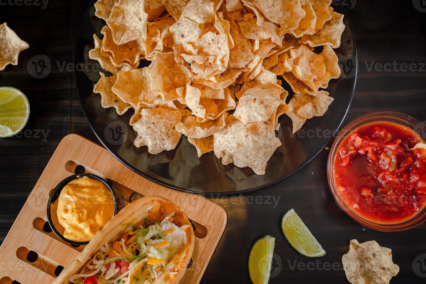 Tacos with Mango Salsa and Chips.Mixed mexican food Guacamole, nachos, fajita, meat tacos. Top view. Tex mex cuisine. photo
