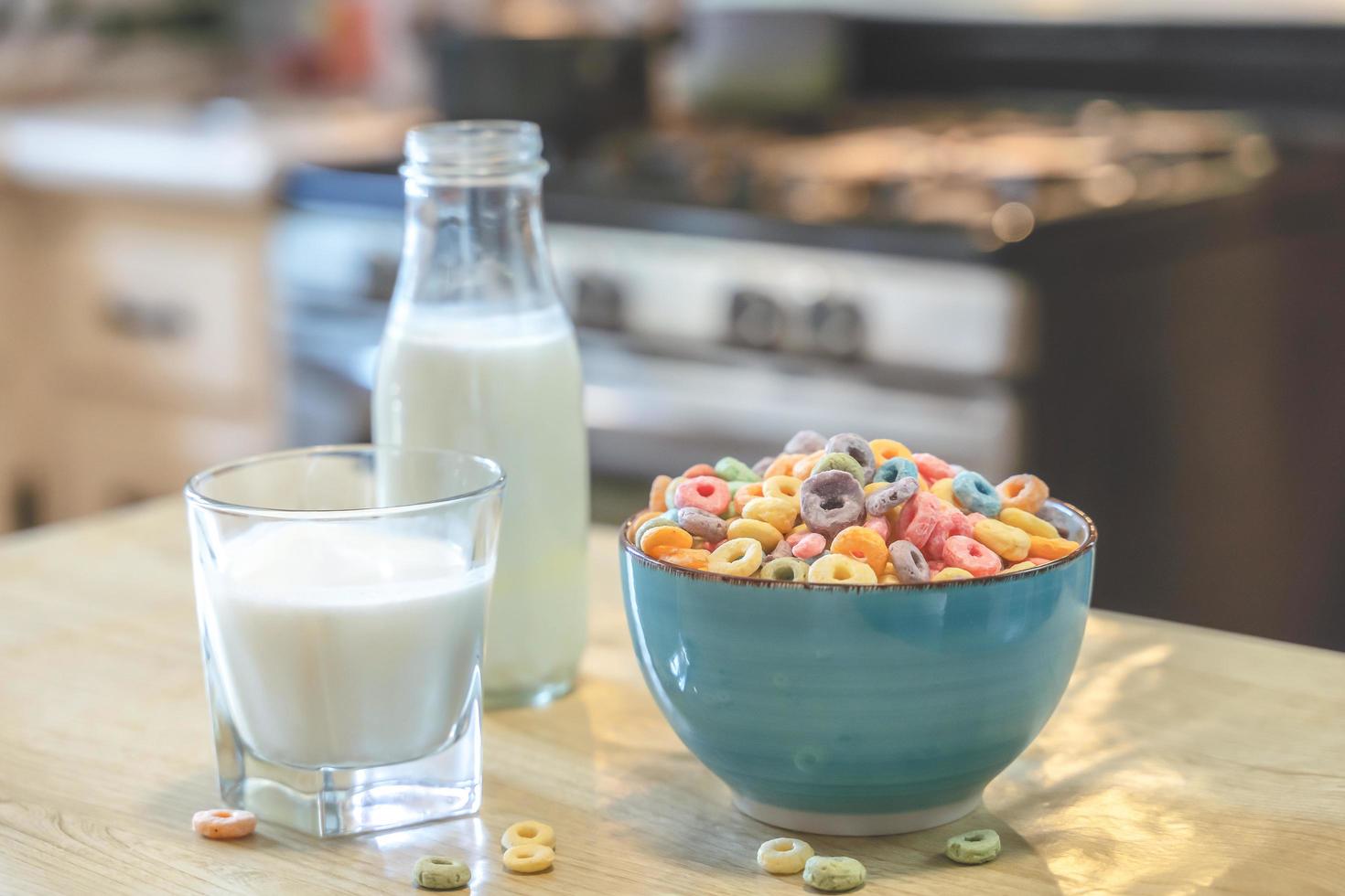 Bowl of colorful children's cereal and milk isolated on wood table with Text space photo