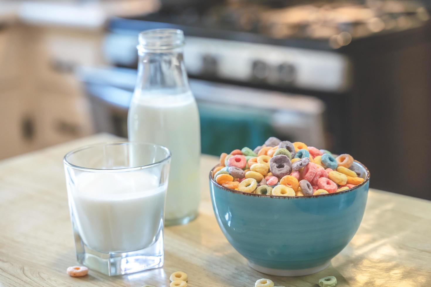 Bowl of colorful children's cereal and milk isolated on wood table with Text space photo