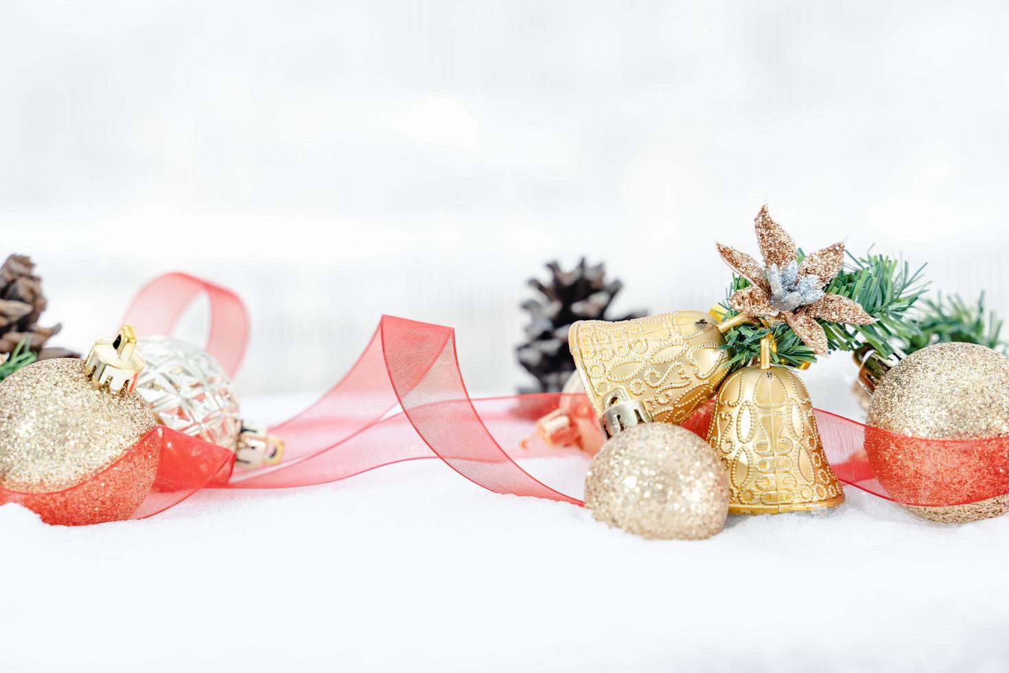 Christmas of  winter - Christmas balls with ribbon on snow, Winter holidays concept. Christmas red balls, golden balls, pine And Snowflakes decorations In Snow Background photo