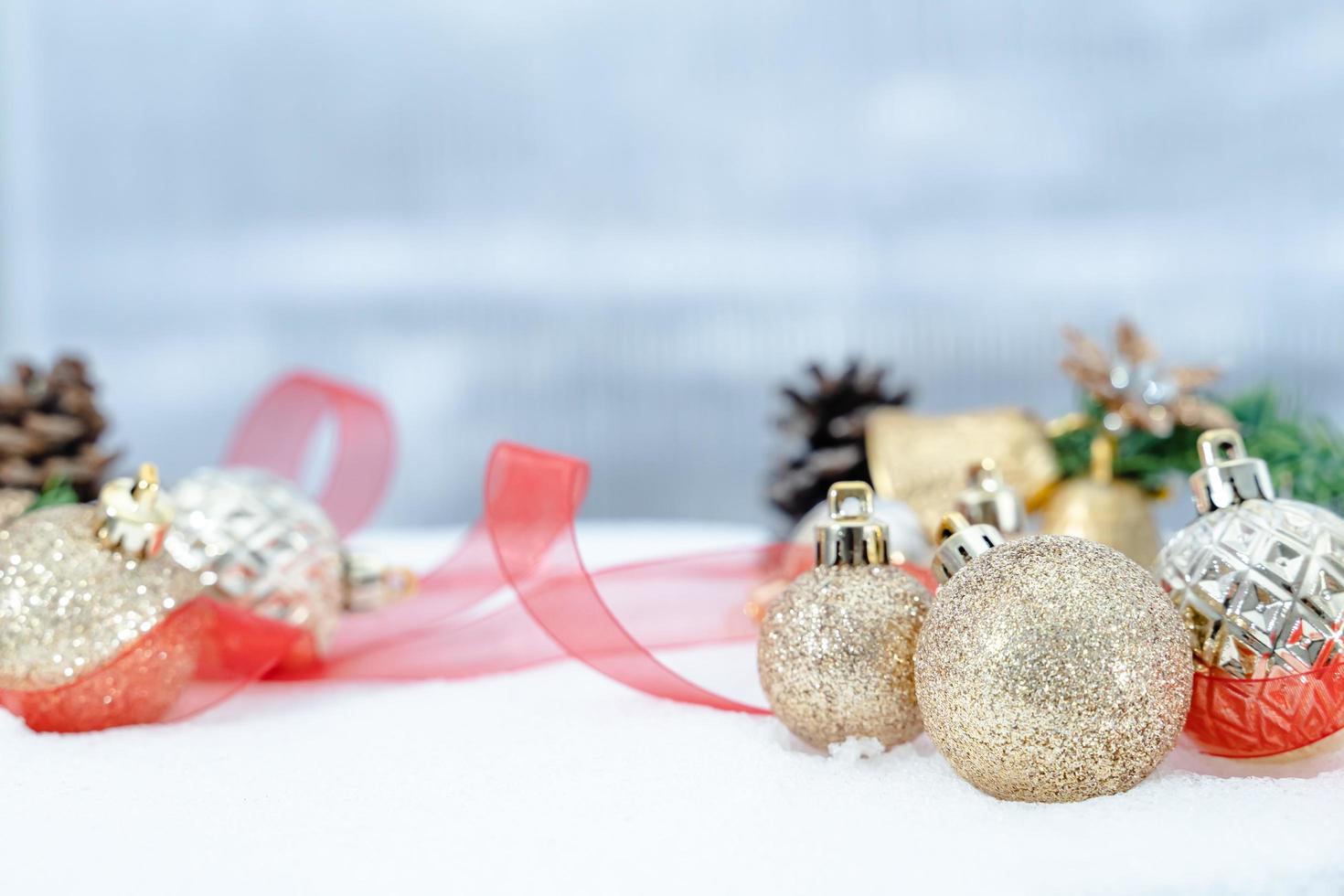 Christmas of  winter - Christmas balls with ribbon on snow, Winter holidays concept. Christmas red balls, golden balls, pine And Snowflakes decorations In Snow Background photo