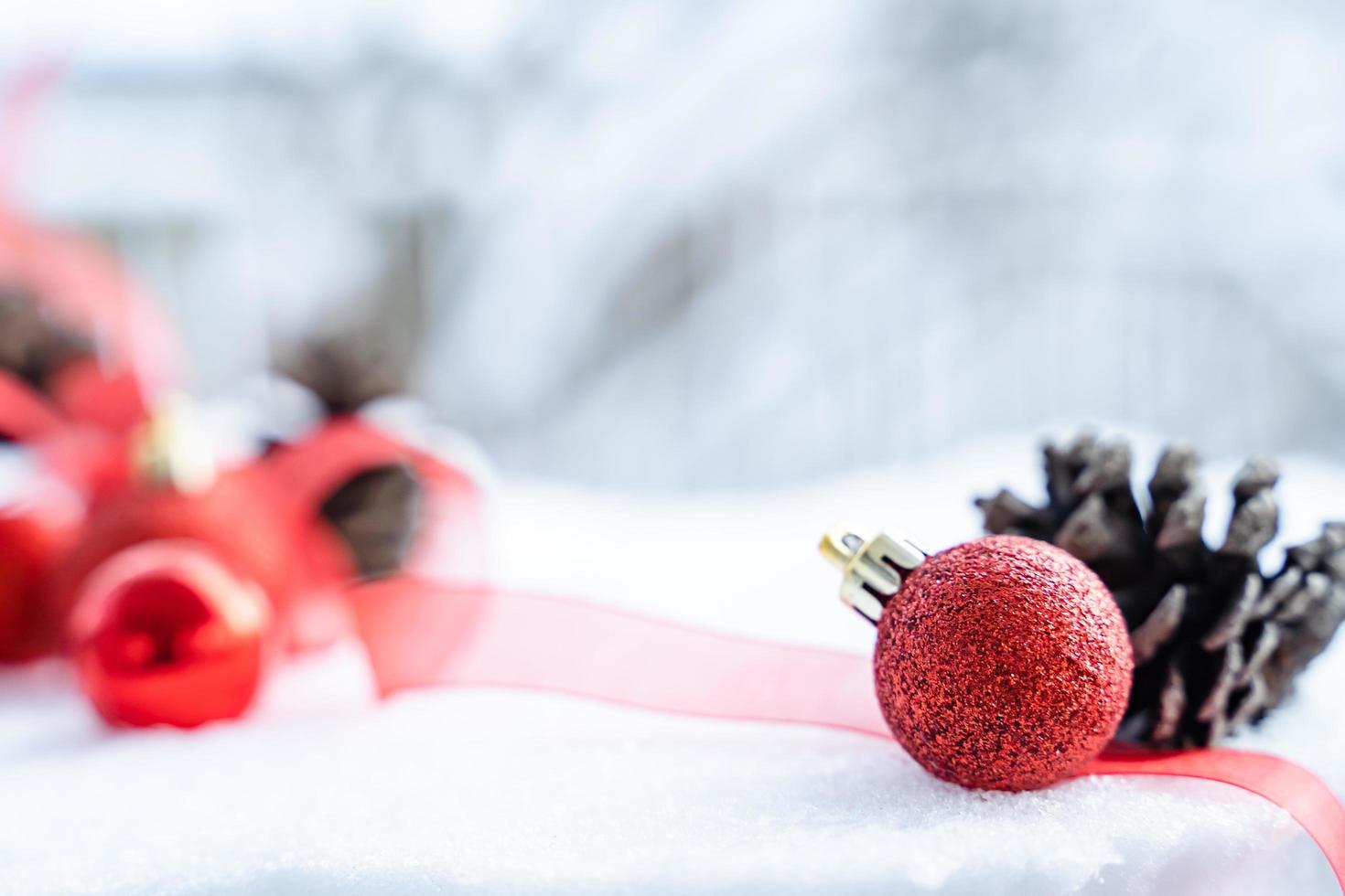 Christmas of  winter - Christmas balls with ribbon on snow, Winter holidays concept. Christmas red balls, golden balls, pine And Snowflakes decorations In Snow Background photo