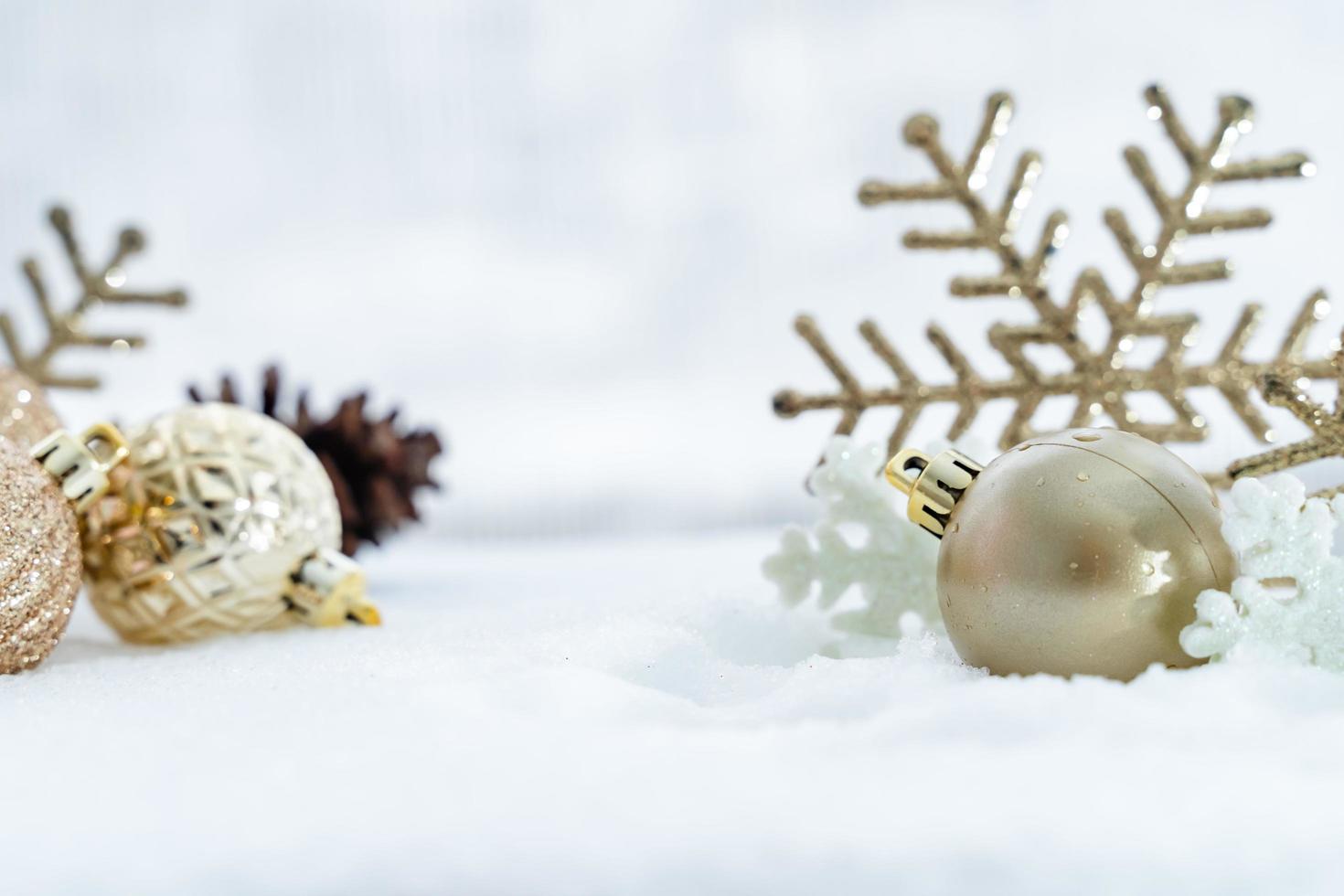 Christmas of  winter - Christmas balls with ribbon on snow, Winter holidays concept. Christmas red balls, golden balls, pine And Snowflakes decorations In Snow Background photo