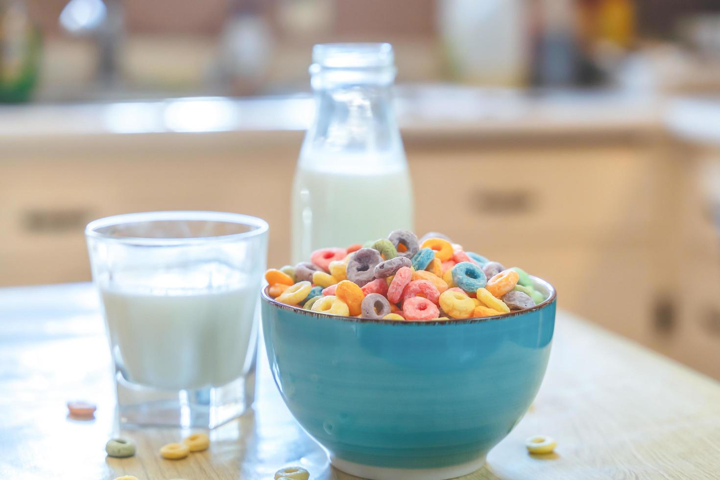 Bowl of colorful children's cereal and milk isolated on wood table with Text space photo