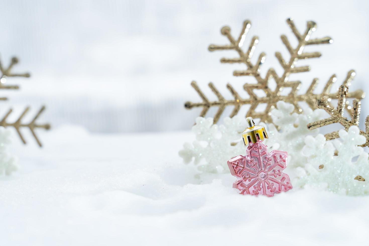 Christmas of  winter - Christmas balls with ribbon on snow, Winter holidays concept. Christmas red balls, golden balls, pine And Snowflakes decorations In Snow Background photo