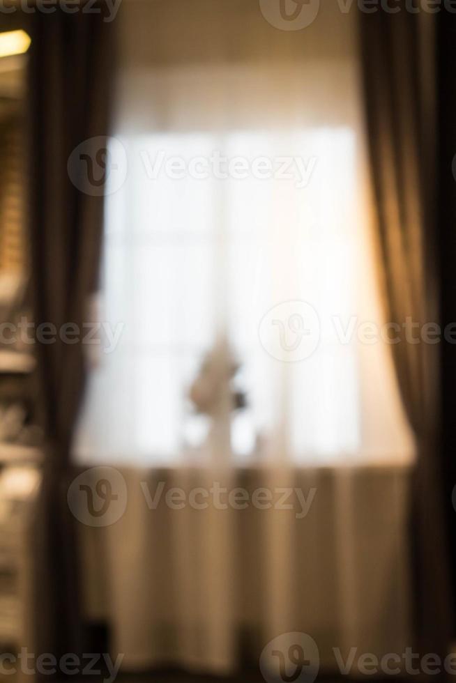 Abstract and blurry image of window with curtains with fir tree photo