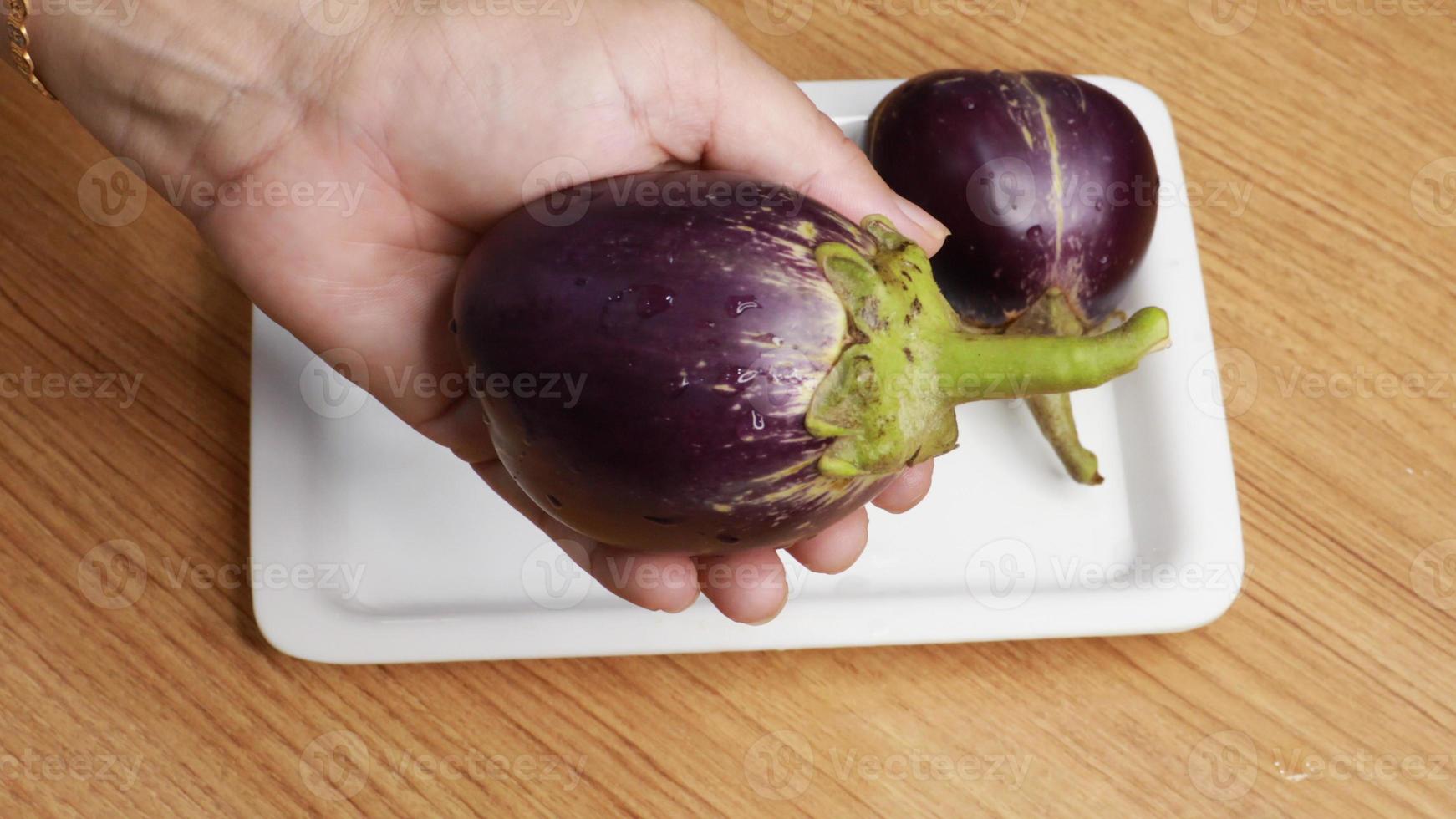 Whole fresh eggplant or aubergine bringal,purple eggplant aubergine steamed cooked with spice and herb for frozen and preserve for later cooking photo