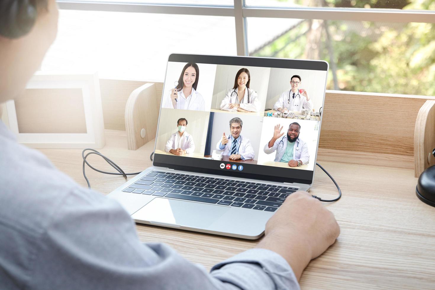 Close-ups on the computer screens a group of doctors greets the patients via online video calls. Concept of medical service. Consult a sick person online During the coronavirus spread photo