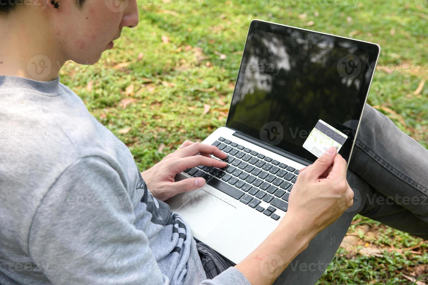 Close up of yong man making online payment, relax time photo