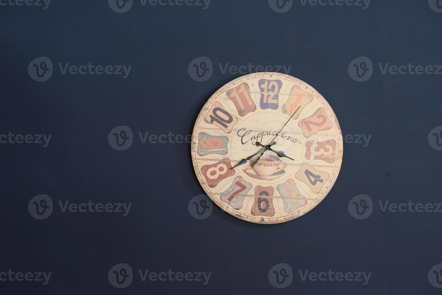 old clock on the navy blue wall photo