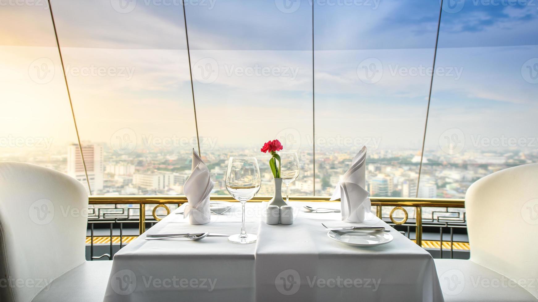 set of empty glasses in a restaurant and view city photo