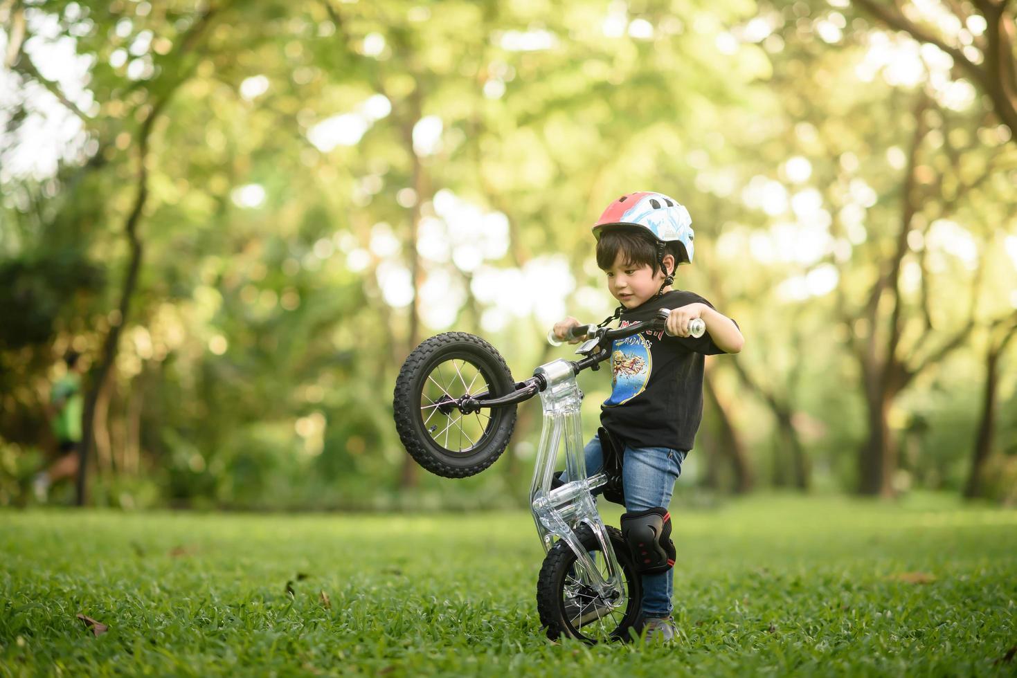 Bangkok Thailand - Oct 09, 2016  happy cheerful child boy riding a bike in Park in the nature photo