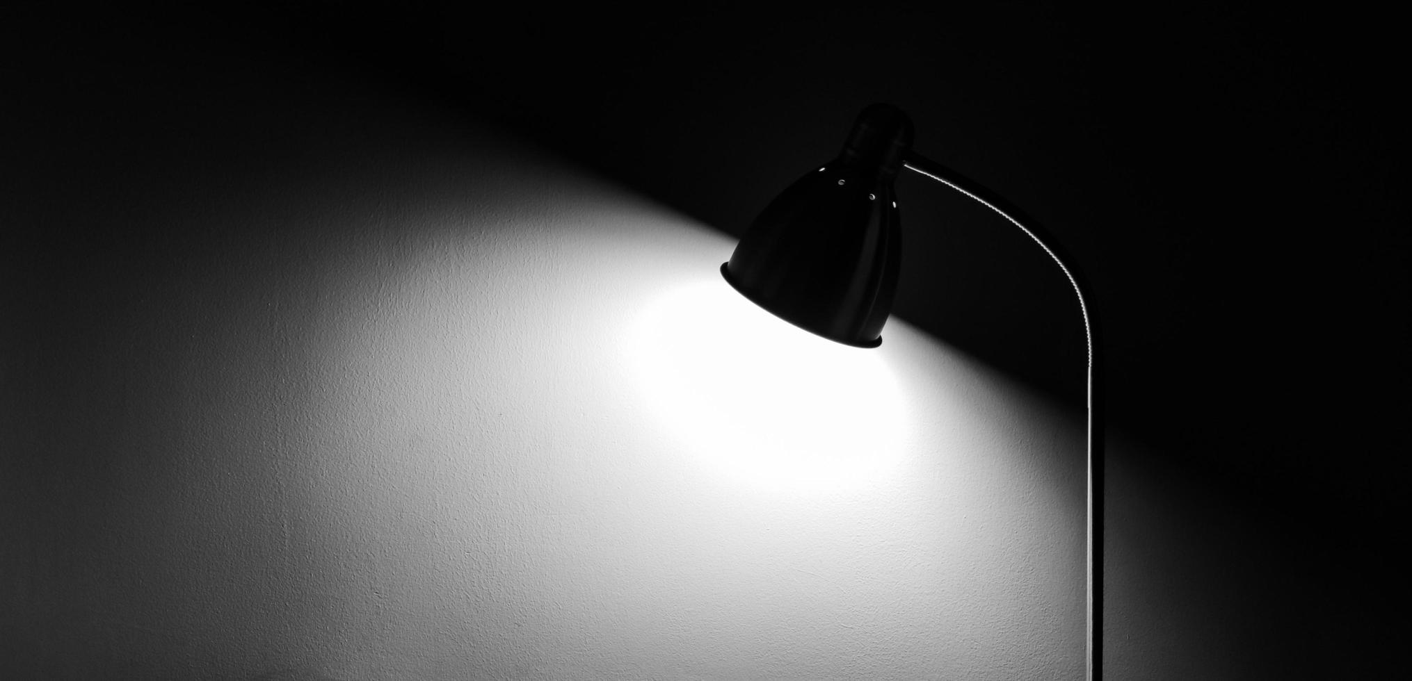 Shadow of floor lamp on concrete wall. photo