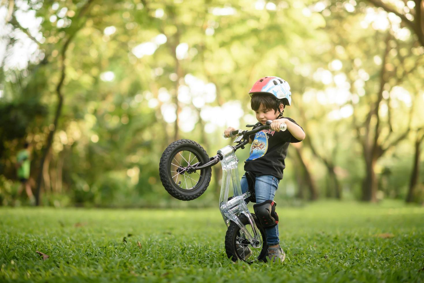 Bangkok Thailand - Oct 09, 2016  happy cheerful child boy riding a bike in Park in the nature photo