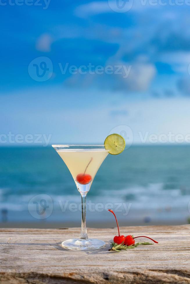 Refreshing cocktail on beach table. photo