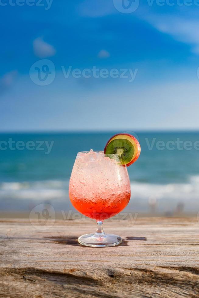 Refreshing cocktail on beach table. photo