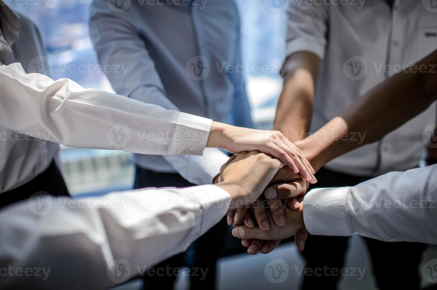 Close up of young businessmen put their hands together. Stack of hands concept of unity and teamwork. photo