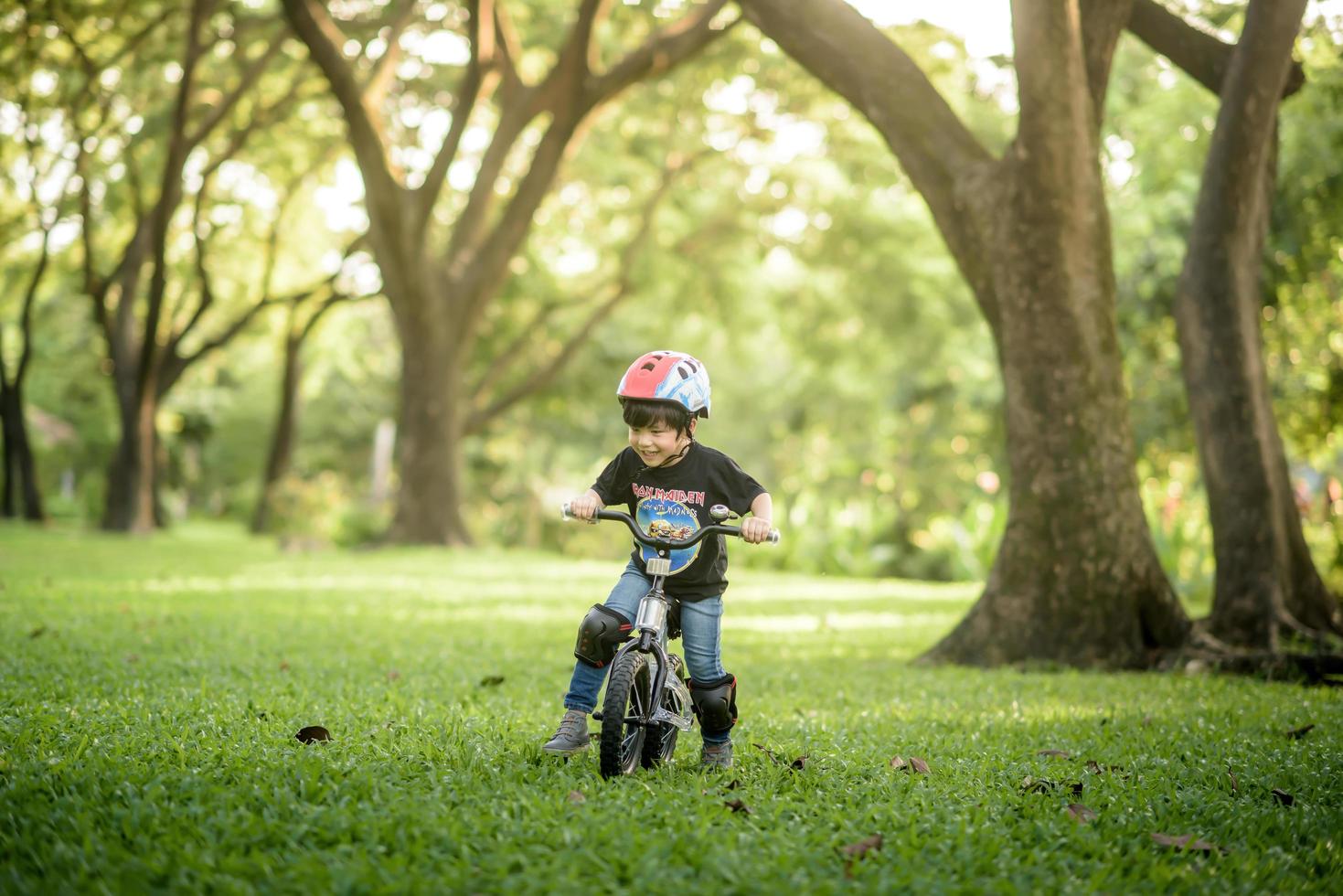 Bangkok Thailand - Oct 09, 2016  happy cheerful child boy riding a bike in Park in the nature photo