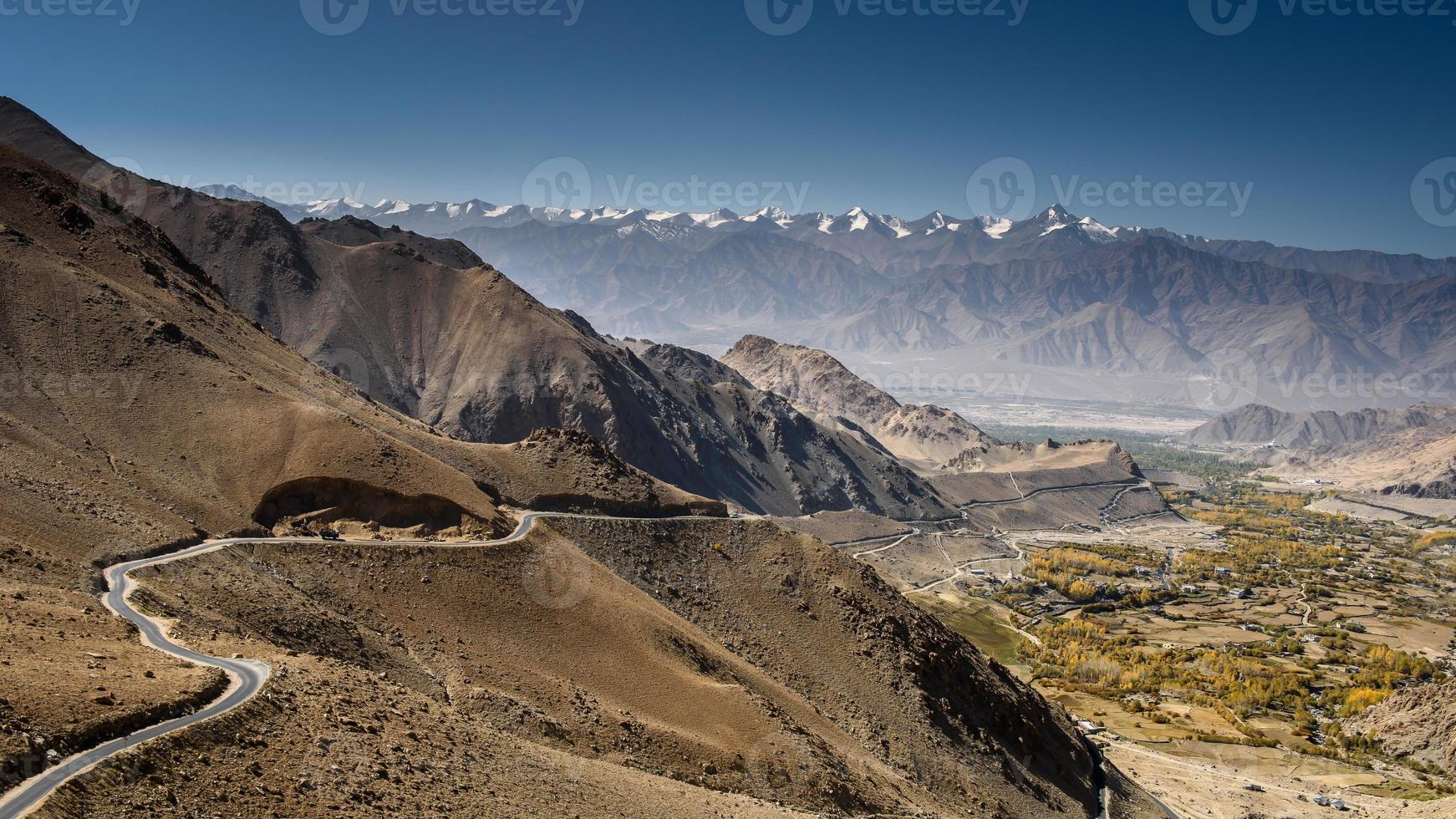 Beautiful view of road to city with mountain and sky background in Leh - Ladakh, northern India. photo