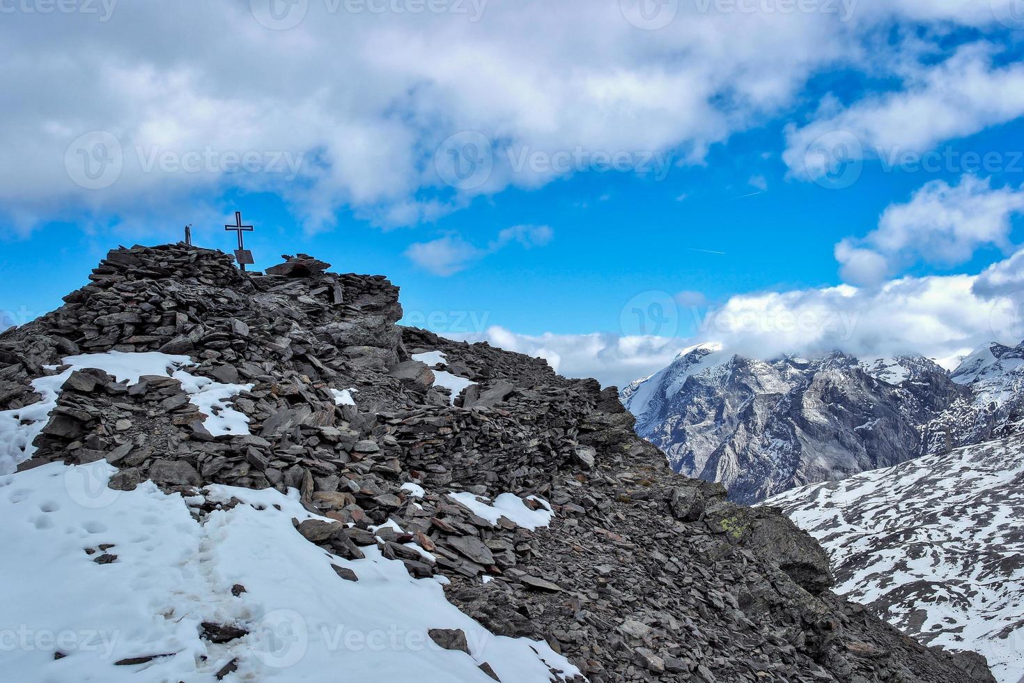 Mountain peak with cross in the italian alps photo