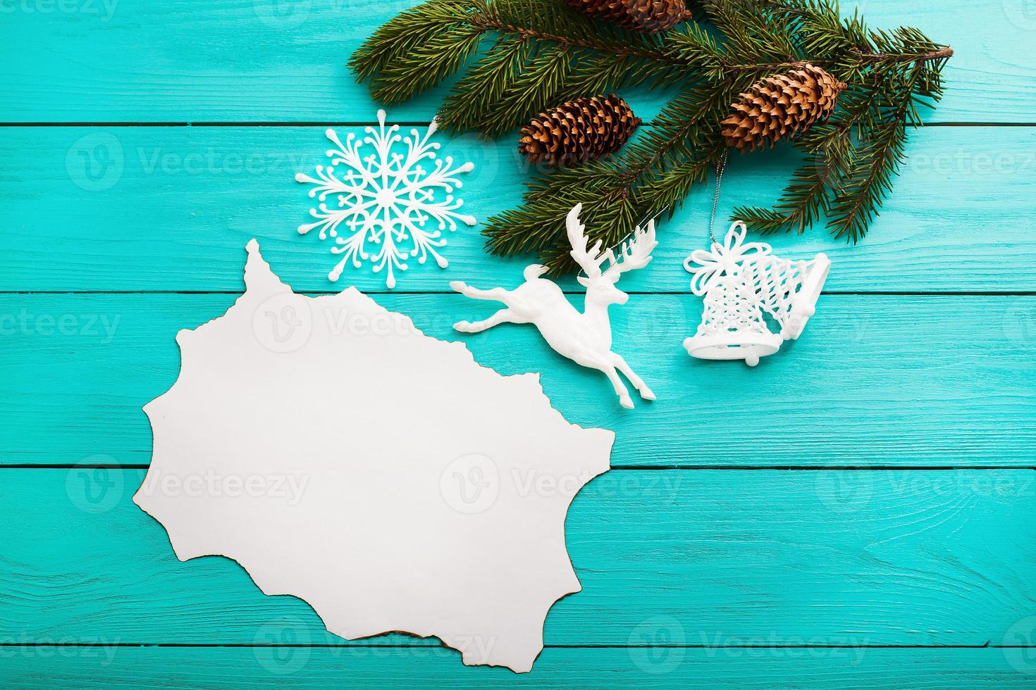 Frame of pine cones on a Christmas tree on blue wooden background. Top view photo