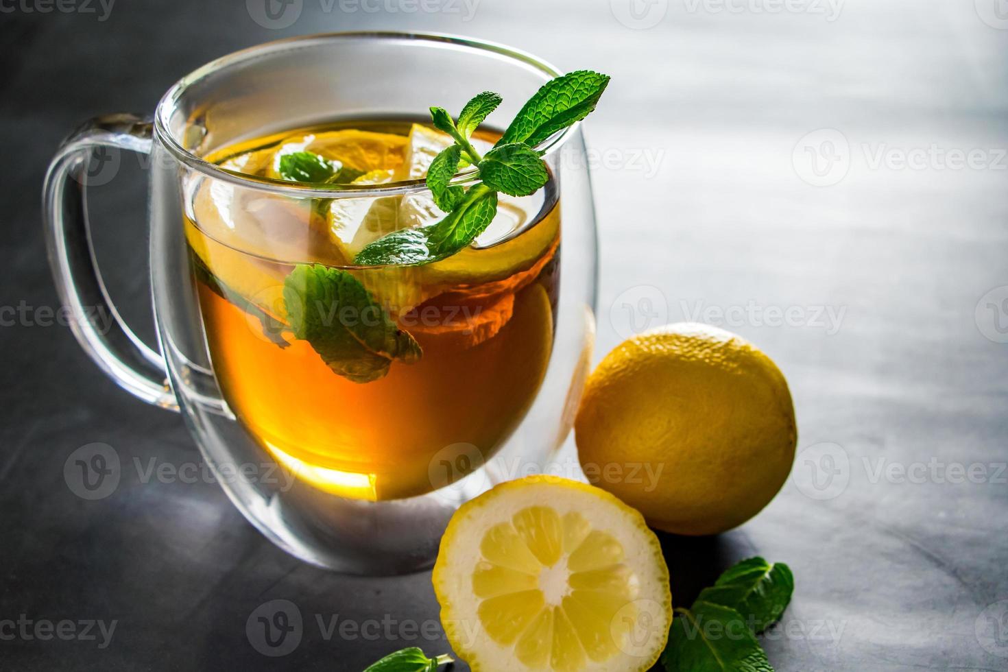 Tea with lemon and mint in transparent cup. Alternative medicine for