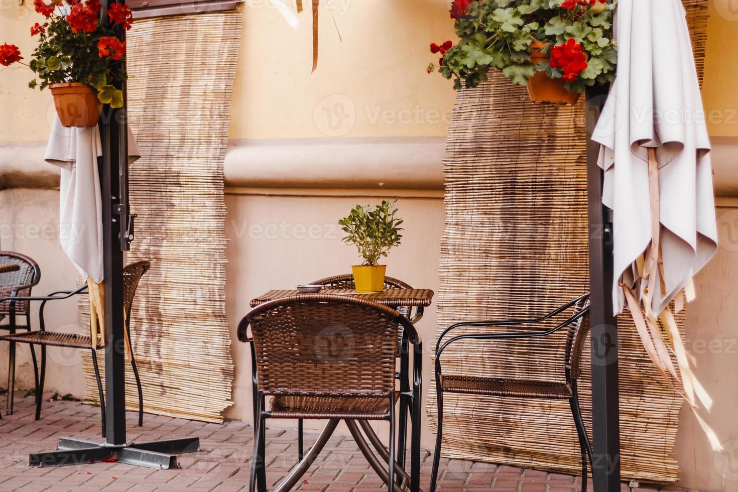 Street cafe in old town. Empty tables and chairs. Autumn city view. Vintage style, trendy neutral colors. photo