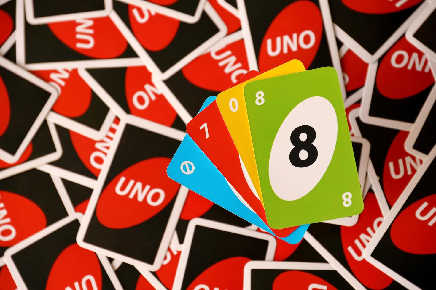 TERNOPIL, UKRAINE - MAY 15, 2022 Many colorful UNO game cards. UNO is an American shedding-type card game that is played with a specially printed deck photo
