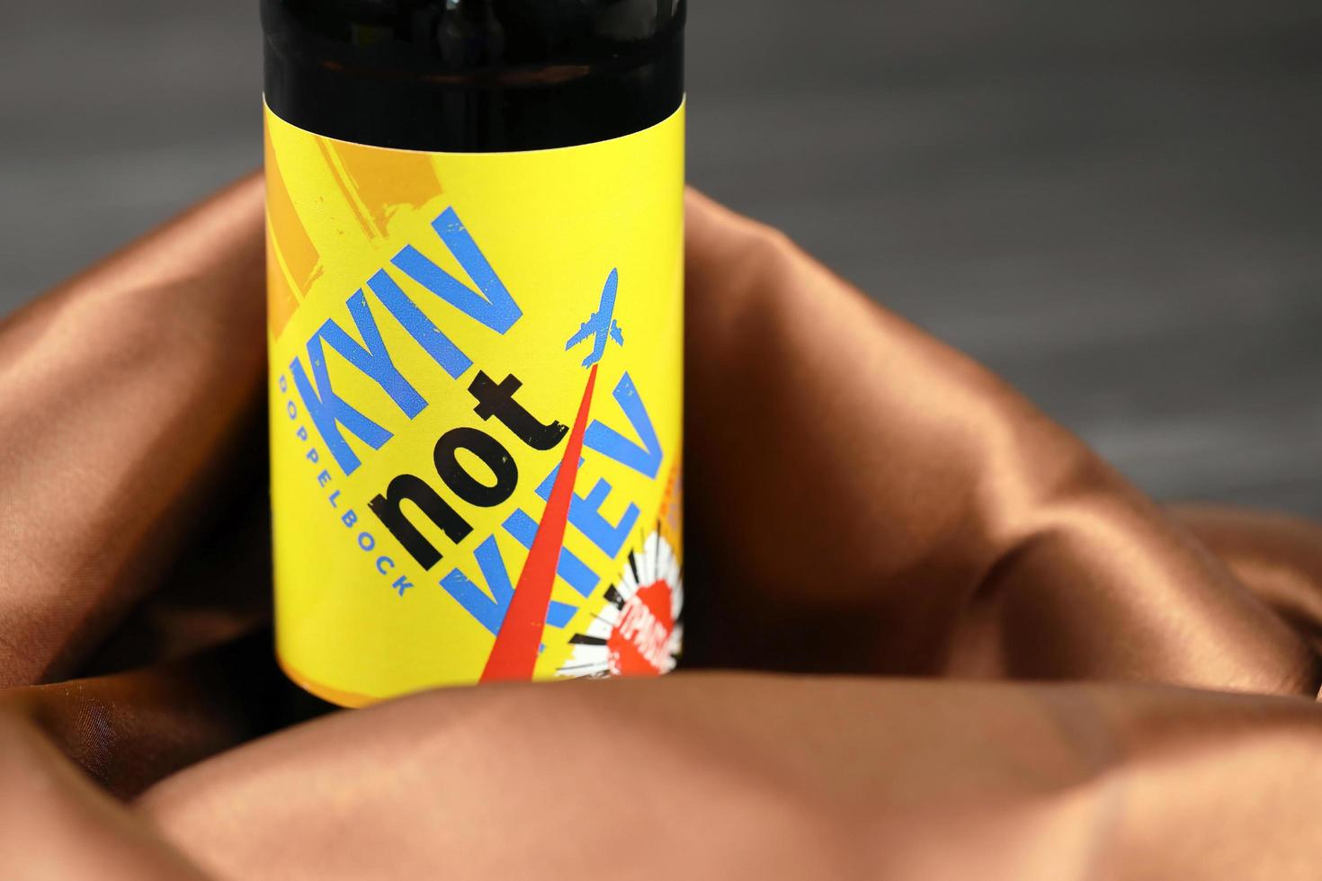 KHARKIV, UKRAINE - NOVEMBER 3, 2021 A bottle of beer featuring Ukrainian capital name Kyiv against his russian spelling Kiev brewed in Pravda Beer Theater in Lviv photo
