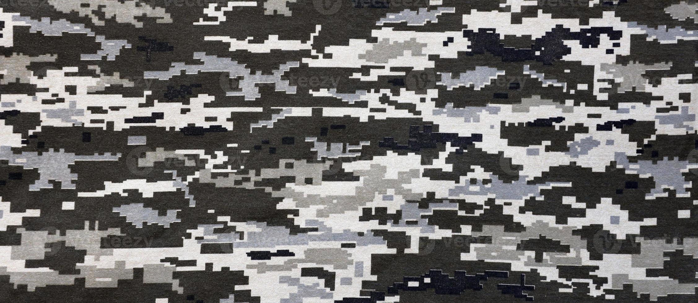 Fabric with texture of Ukrainian military pixeled camouflage. Cloth with camo pattern in grey, brown and green pixel shapes. Official uniform of Ukrainian soldiers photo