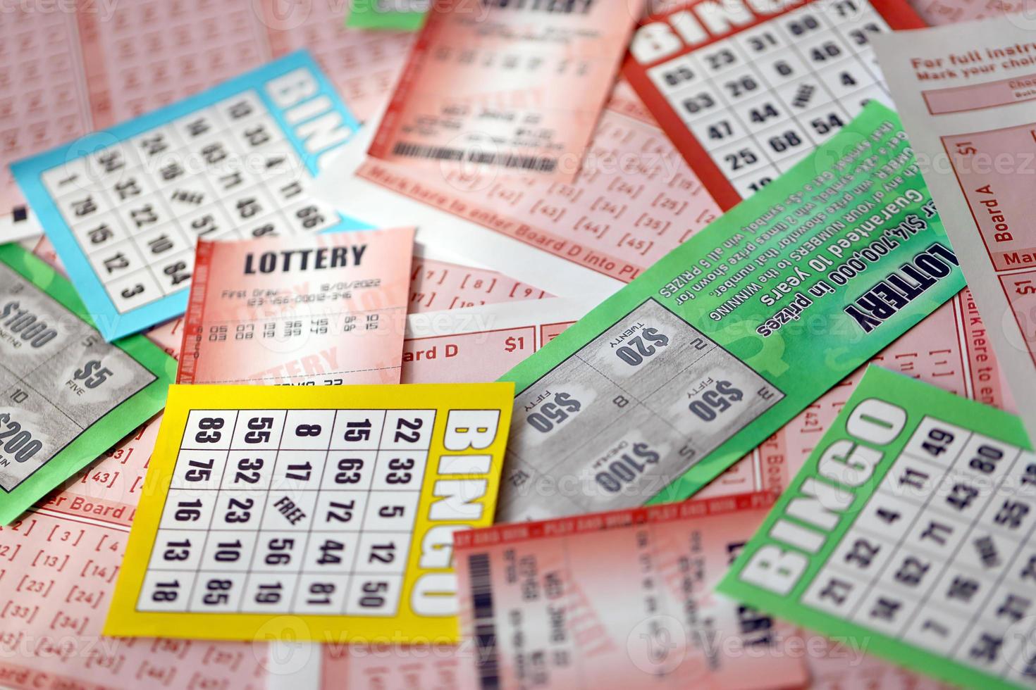 Many used lottery tickets, bills with numbers and bingo playing boards in big pile. Gambling and lottery paper stuff photo