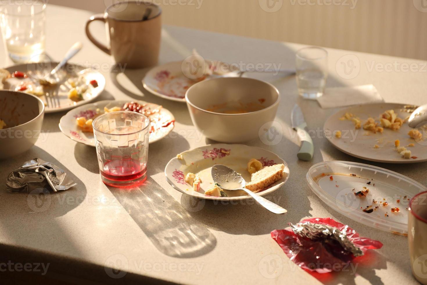 Empty dirty plates with spoons and forks on the table after meal. Banquet ending concept. Unwashed dishes photo