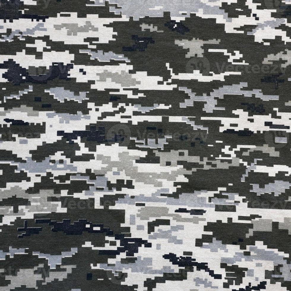 Fabric with texture of Ukrainian military pixeled camouflage. Cloth with camo pattern in grey, brown and green pixel shapes. Official uniform of Ukrainian soldiers photo