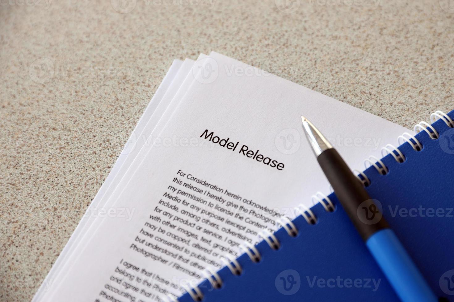 Model release blank form with blue notepad and blue pen lies on photographers table. Model release signing photo