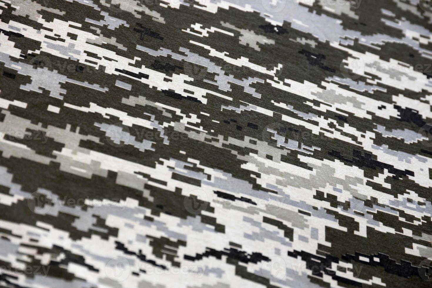 Fabric with texture of Ukrainian military pixeled camouflage. Cloth with camo pattern in grey, brown and green pixel shapes. Official uniform of Ukrainian soldiers photo