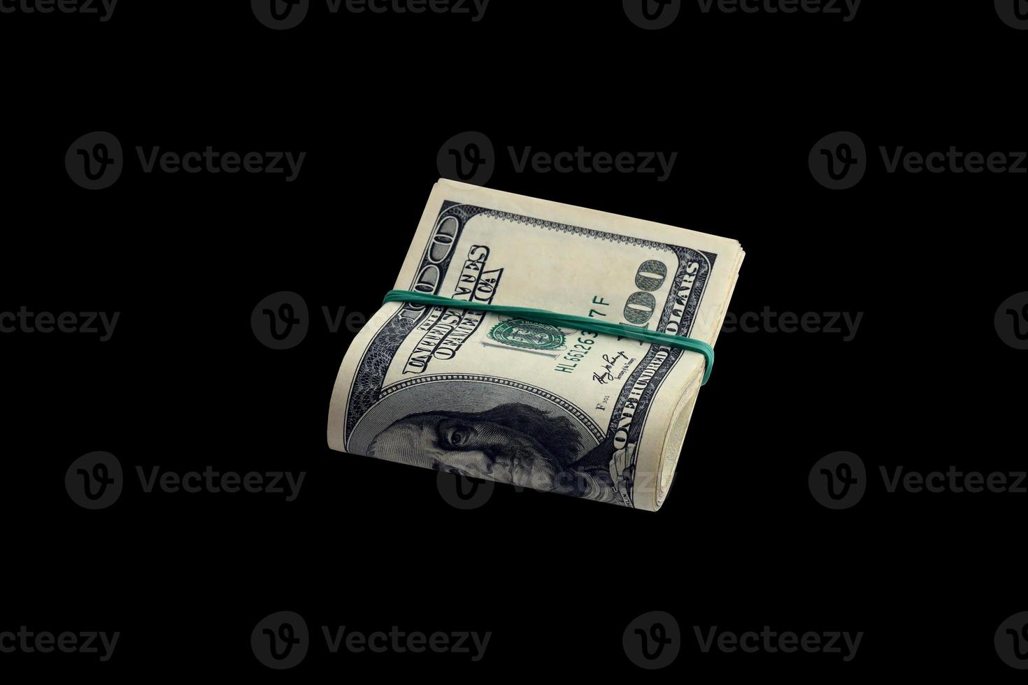 Bundle of US dollar bills isolated on black. Pack of american money with high resolution on perfect black background photo